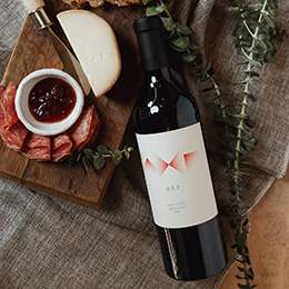 Bottle of AXR Ganzin Red with charcuterie platter